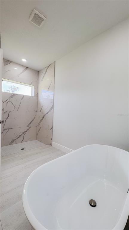 15625 Southwest 37th Circle Ocala, FL 34473 - Photo 26 of 27 a bathroom with a tub and a shower