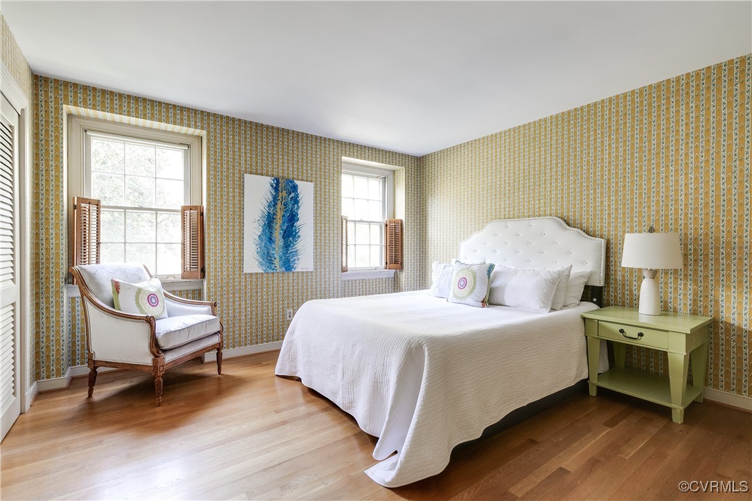 201 Wood Road Henrico, VA 23229 - Photo 22 of 40 a bedroom with a bed wooden floor and windows