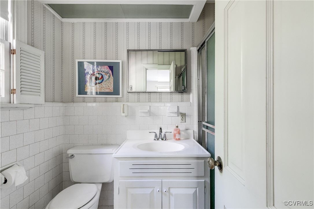 201 Wood Road Henrico, VA 23229 - Photo 29 of 40 a bathroom with a toilet sink and mirror