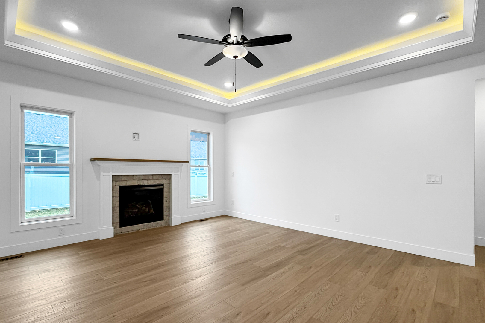 606 Kevin Road Blue Grass, IA 52726 - Photo 19 of 33 a view of an empty room with wooden floor fireplace and a window