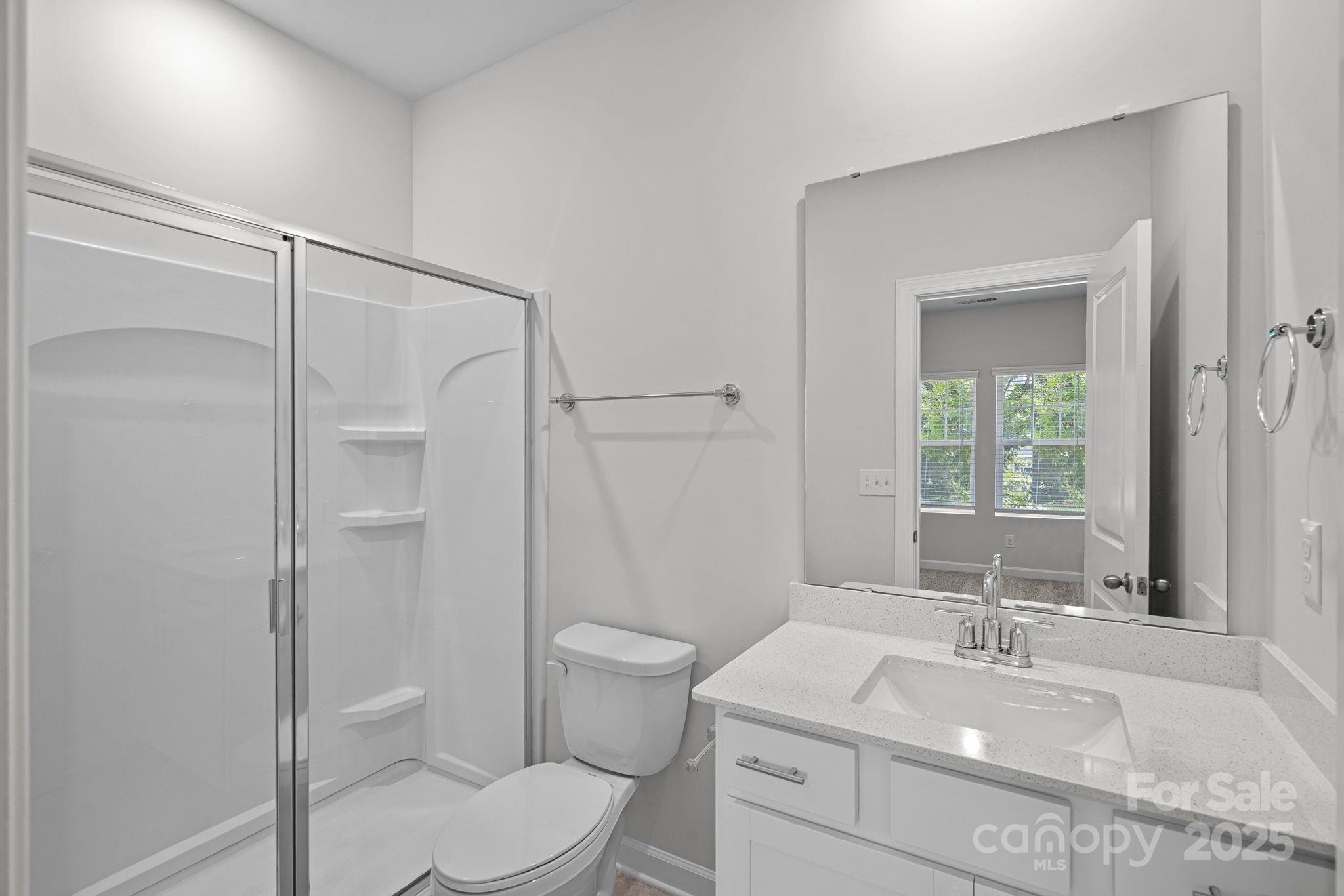 2426 Arbor Loop Drive Charlotte, NC 28217 - Photo 7 of 23 a bathroom with a sink toilet vanity and shower