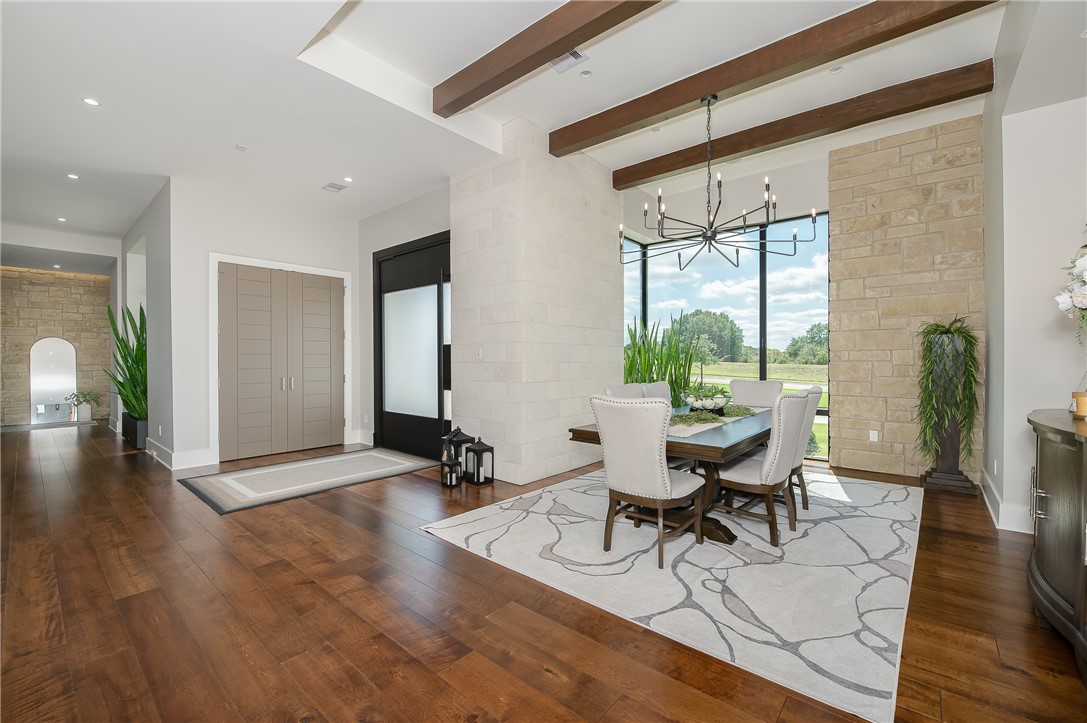 3320 Sycamore Trail Bryan, TX 77807 - Photo 3 of 48 Dining room featuring baseboards, recessed lighting, beam ceiling, hardwood / wood-style floors, and a notable chandelier
