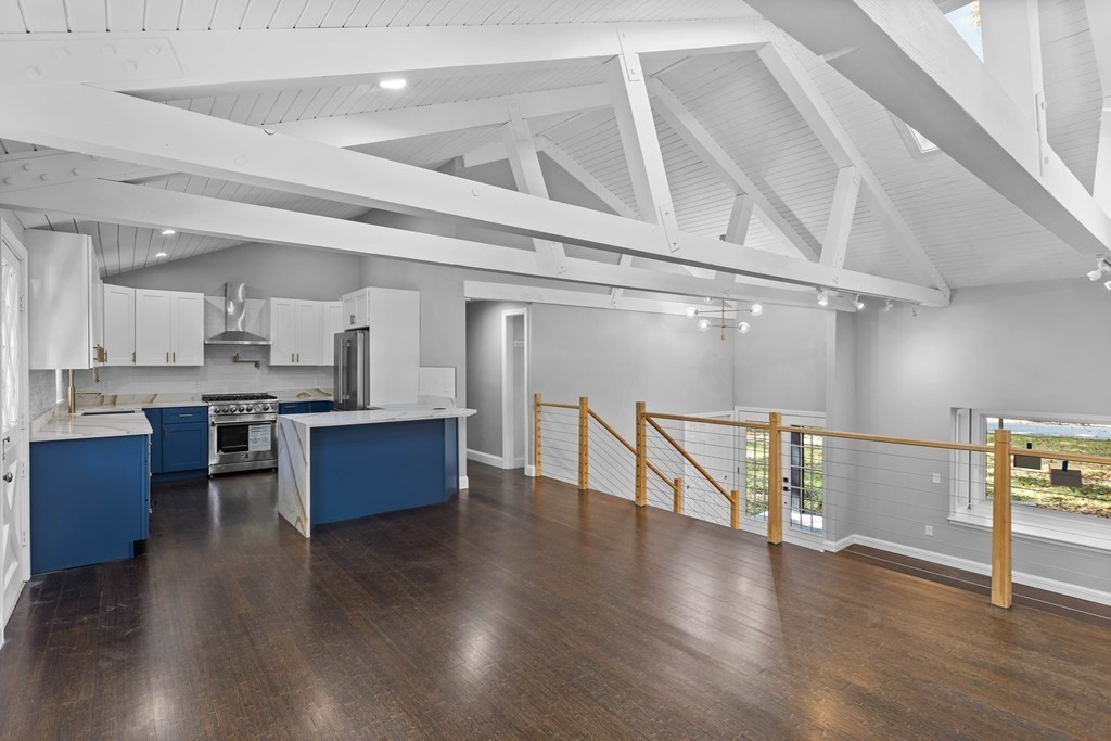 8 Edgewater Drive Dover, MA 02030 - Photo 1 of 31 a kitchen with stainless steel appliances kitchen island wooden floors and view living room