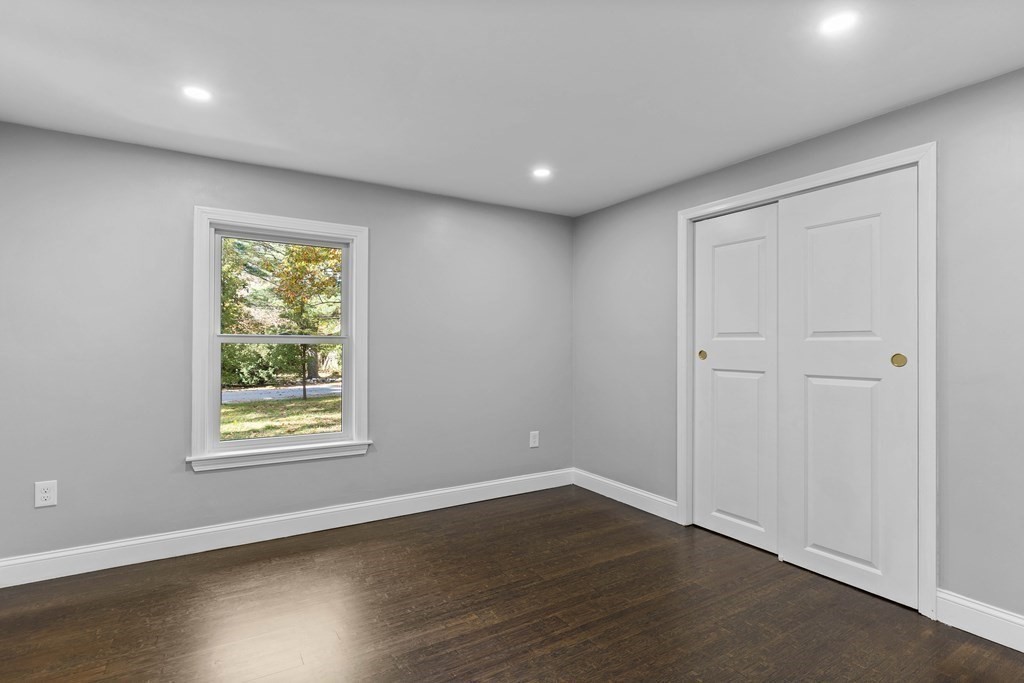 8 Edgewater Drive Dover, MA 02030 - Photo 17 of 31 an empty room with wooden floor and windows