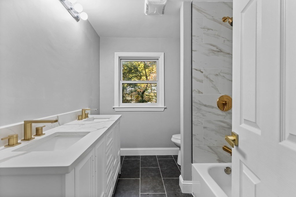8 Edgewater Drive Dover, MA 02030 - Photo 18 of 31 a bathroom with a granite countertop sink a toilet and shower