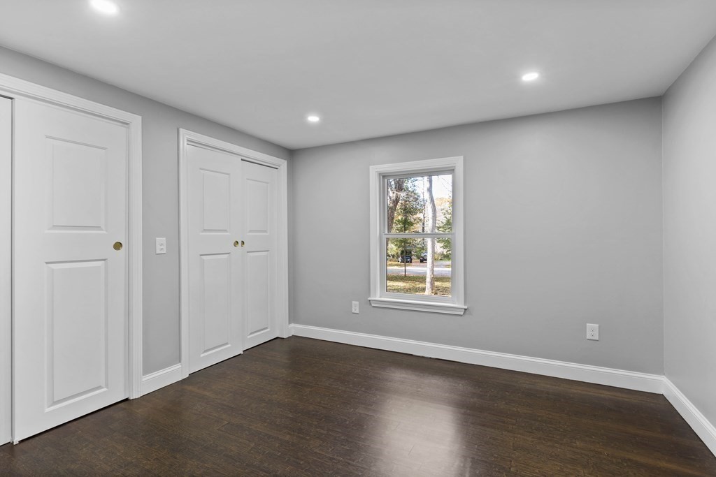 8 Edgewater Drive Dover, MA 02030 - Photo 19 of 31 an empty room with wooden floor and windows