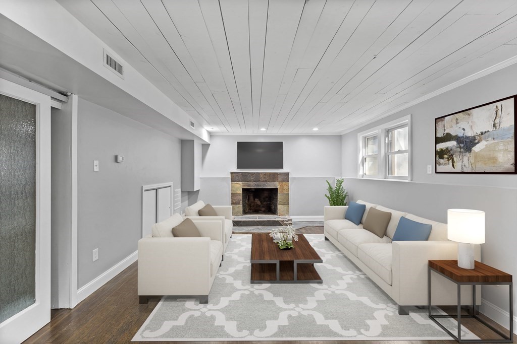8 Edgewater Drive Dover, MA 02030 - Photo 21 of 31 a living room with furniture a fireplace and a flat screen tv