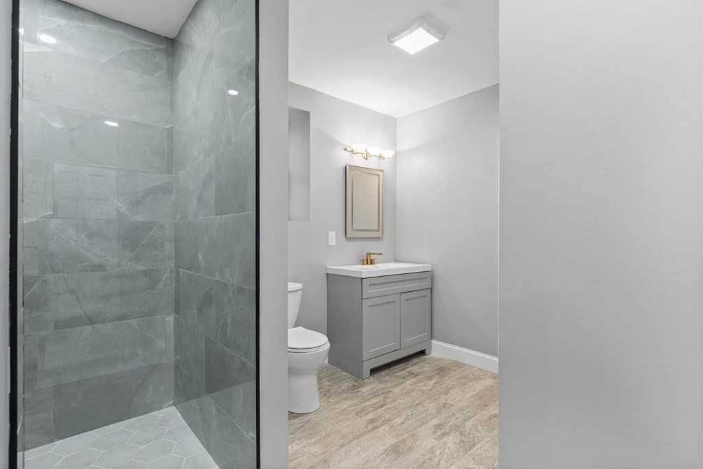 8 Edgewater Drive Dover, MA 02030 - Photo 22 of 31 a bathroom with a sink a toilet and shower