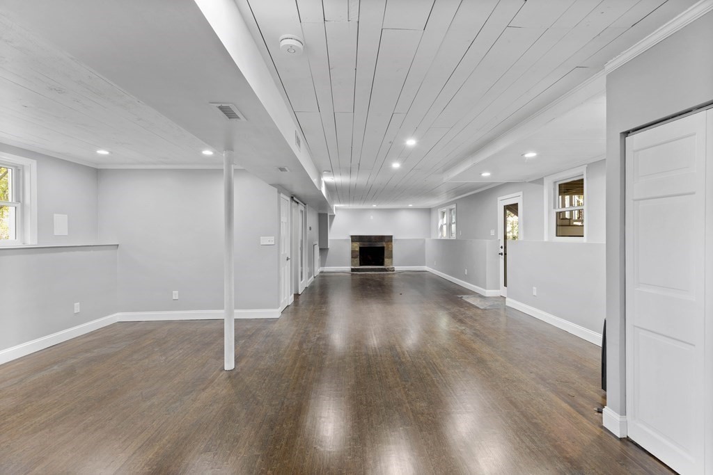 8 Edgewater Drive Dover, MA 02030 - Photo 23 of 31 an empty room with wooden floor and windows