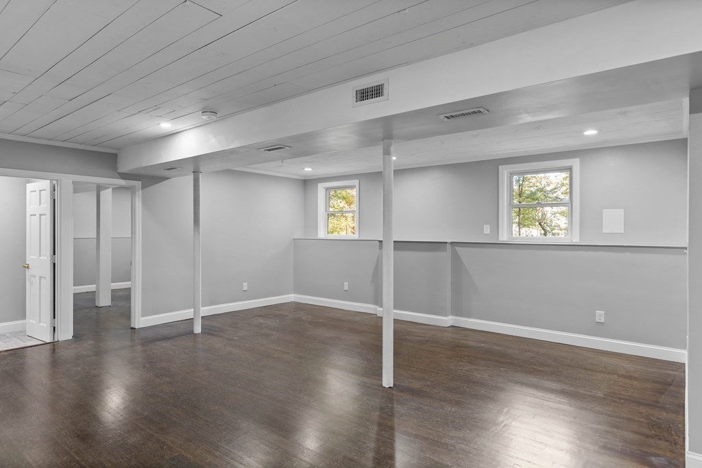 8 Edgewater Drive Dover, MA 02030 - Photo 24 of 31 an empty room with wooden floor and windows