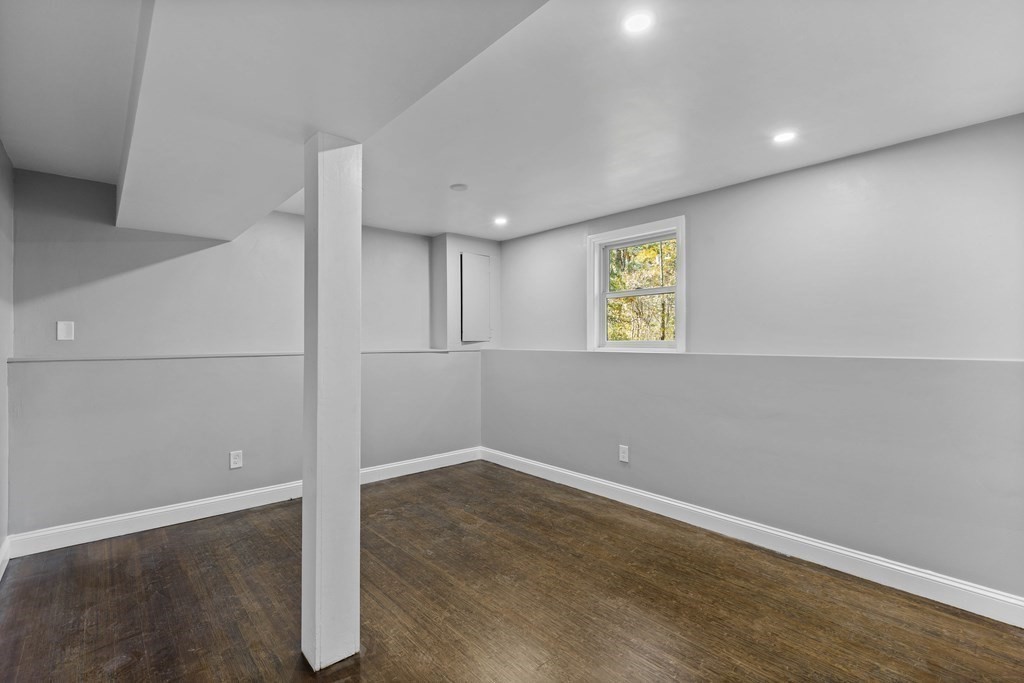 8 Edgewater Drive Dover, MA 02030 - Photo 25 of 31 an empty room with wooden floor and windows