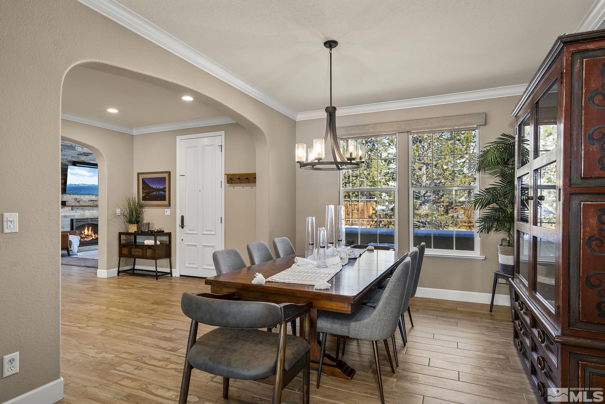 8370 Cinnamon Ridge Lane Reno, NV 89523 - Photo 9 of 40 a dining room with furniture wooden floor a chandelier and a rug