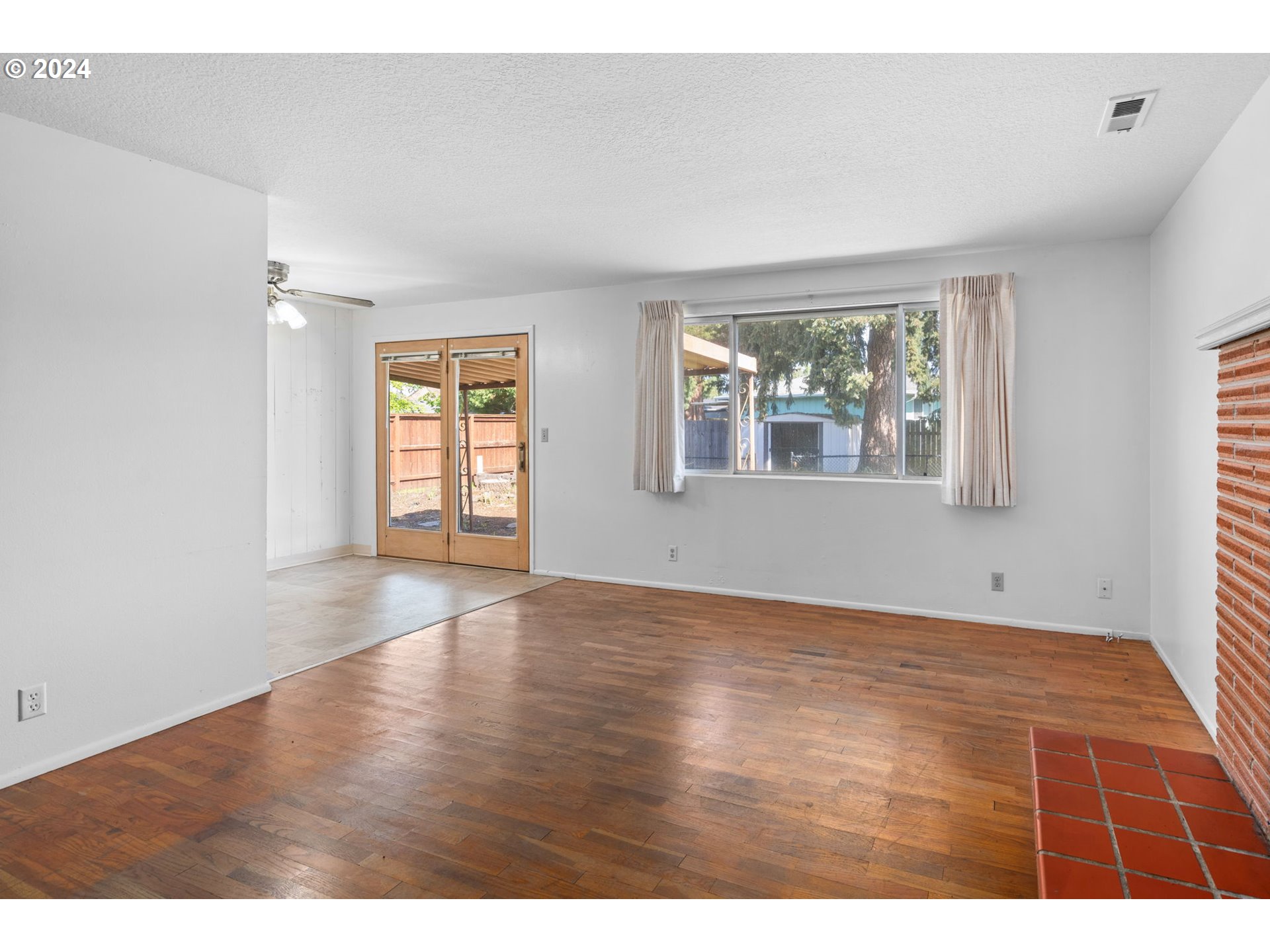 5246 E Street Springfield, OR 97478 - Photo 11 of 26 a view of an empty room with wooden floor and a window