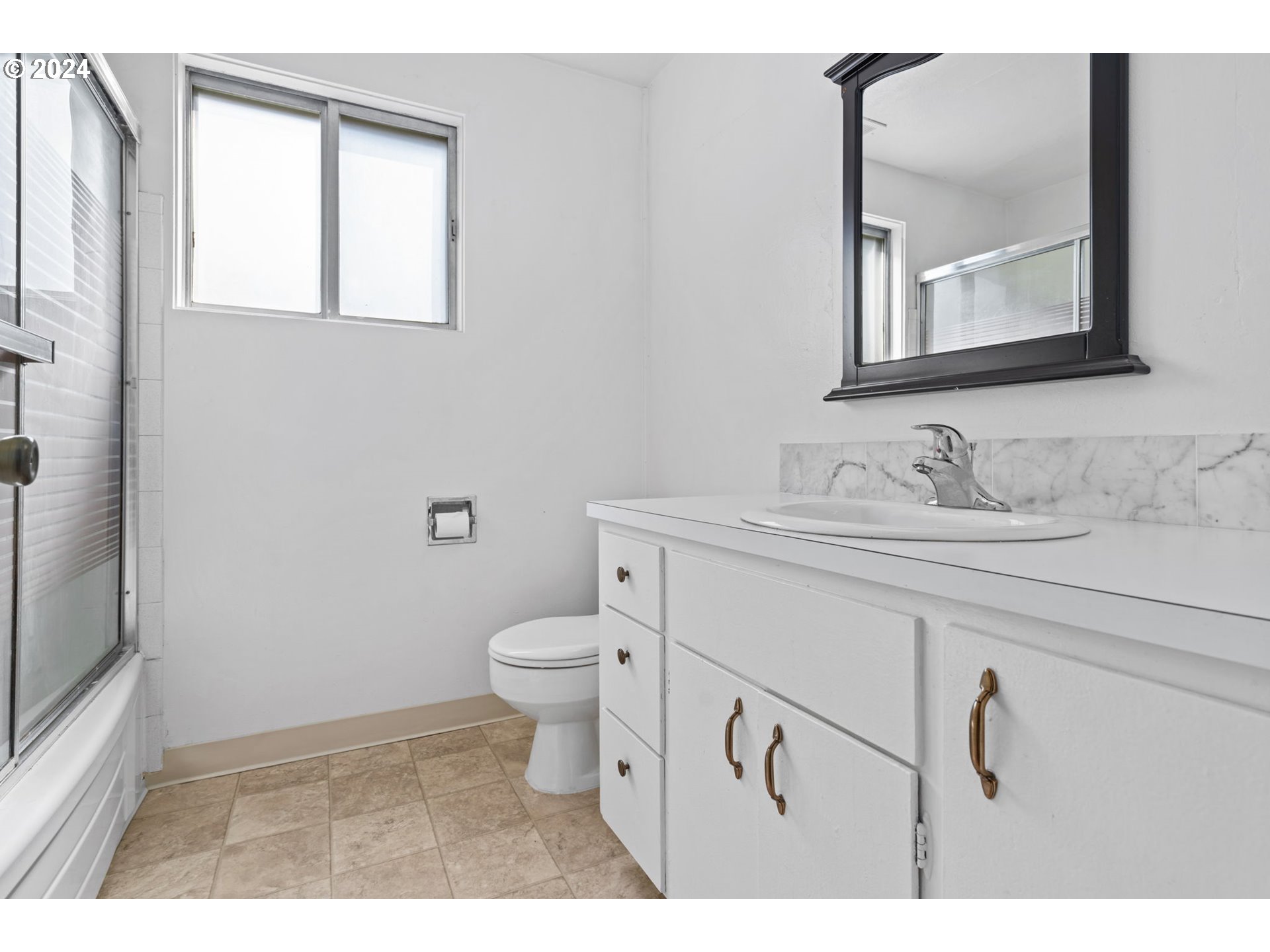 5246 E Street Springfield, OR 97478 - Photo 17 of 26 a bathroom with a toilet sink and mirror