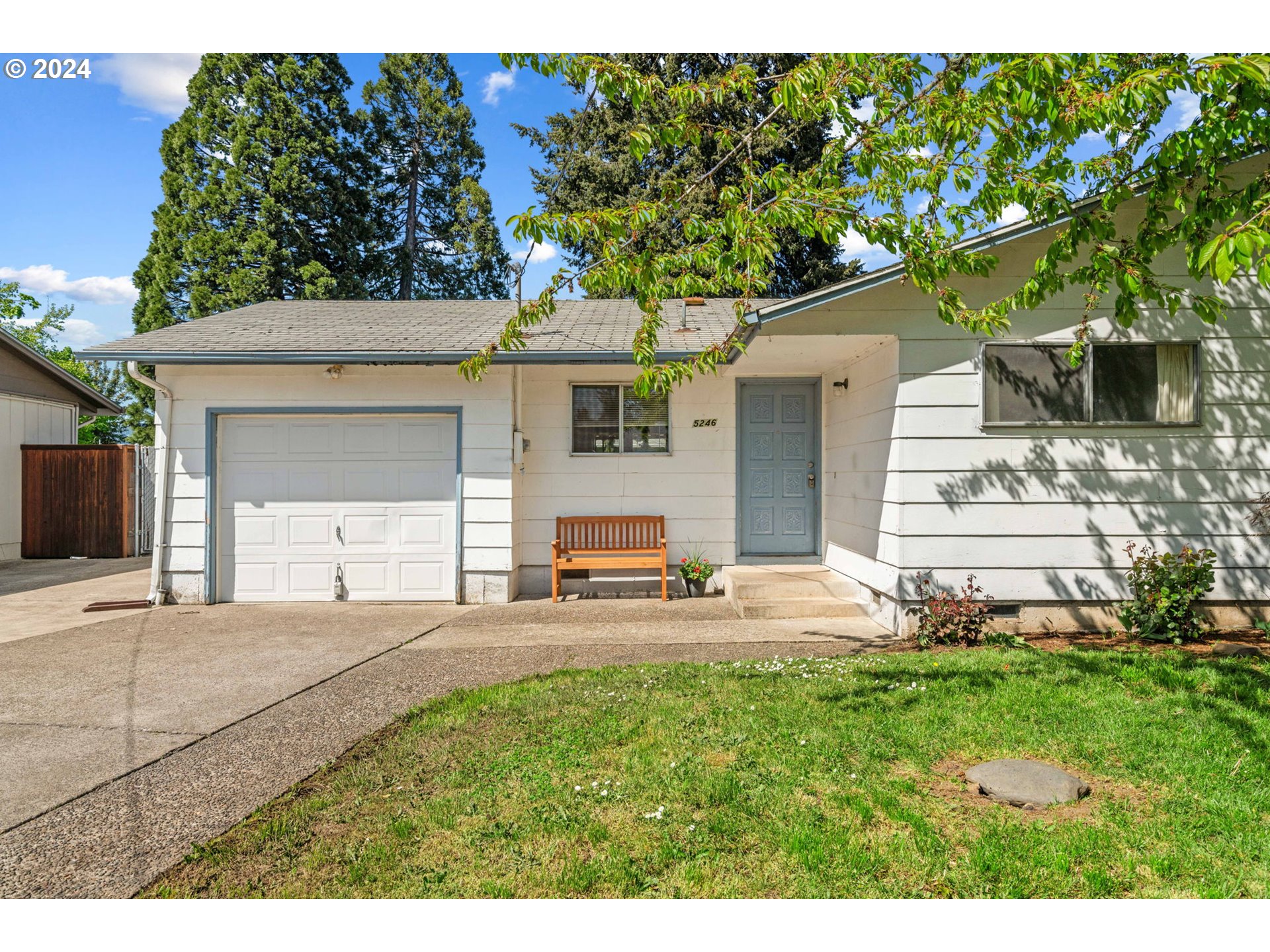 5246 E Street Springfield, OR 97478 - Photo 2 of 26 a front view of a house with a yard and a garage