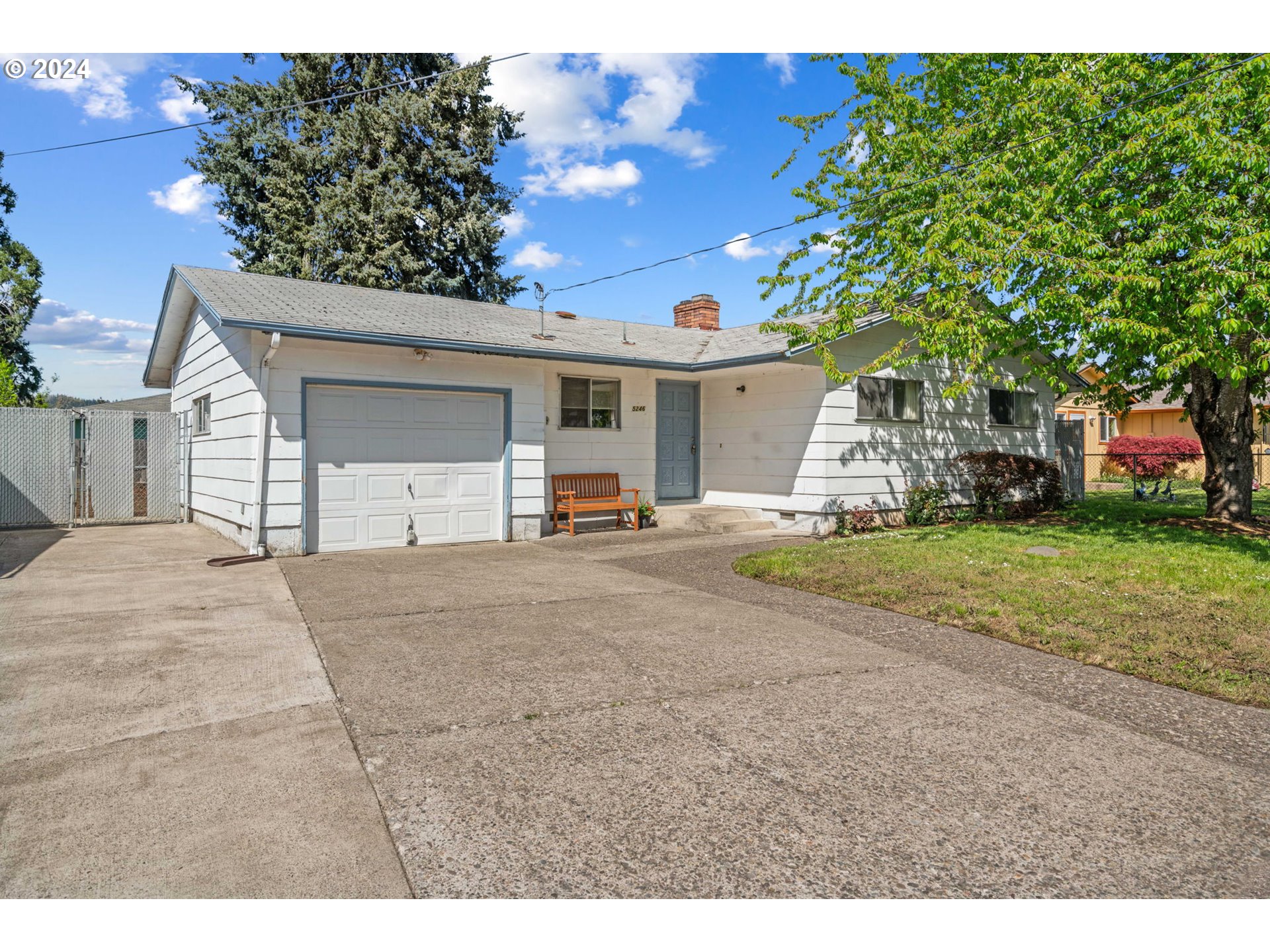 5246 E Street Springfield, OR 97478 - Photo 3 of 26 a view of a house with a yard and garage