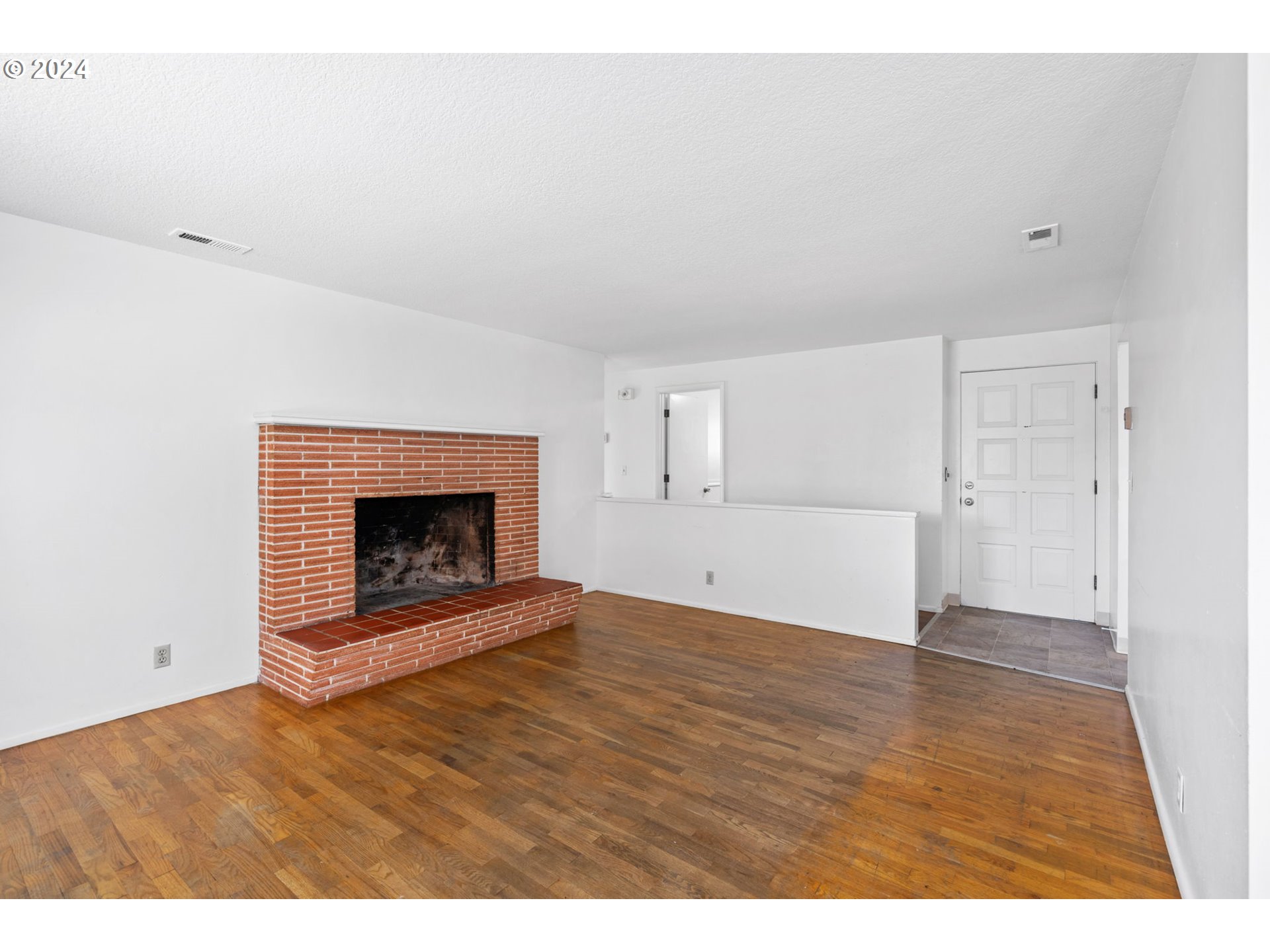 5246 E Street Springfield, OR 97478 - Photo 6 of 26 a view of an empty room with wooden floor a fireplace