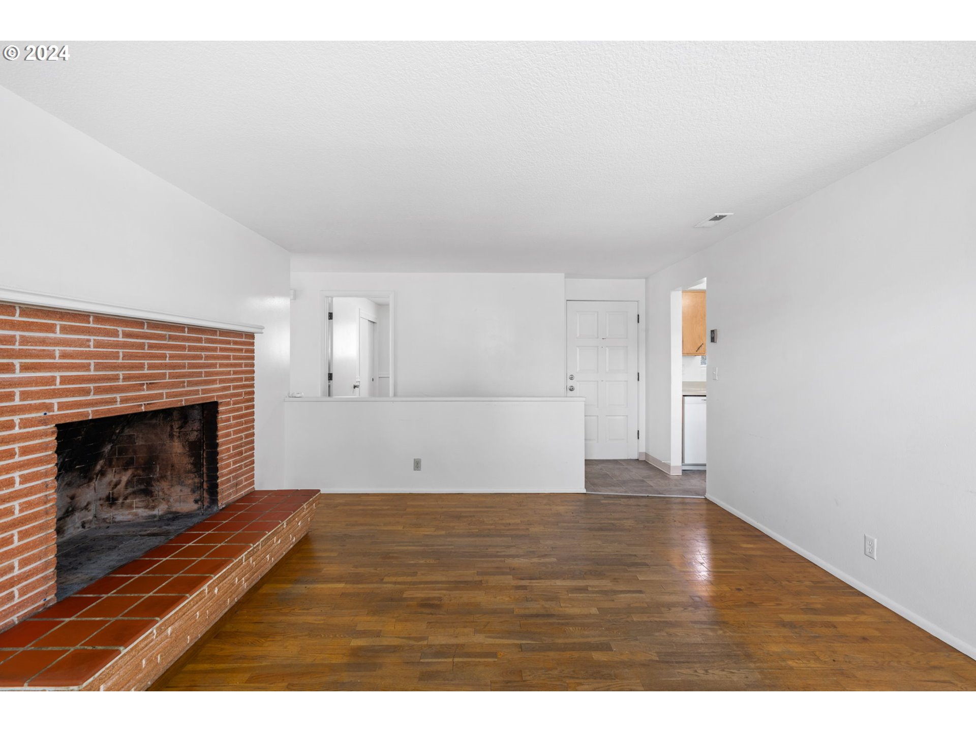 5246 E Street Springfield, OR 97478 - Photo 7 of 26 a view of empty room with wooden floor and fireplace