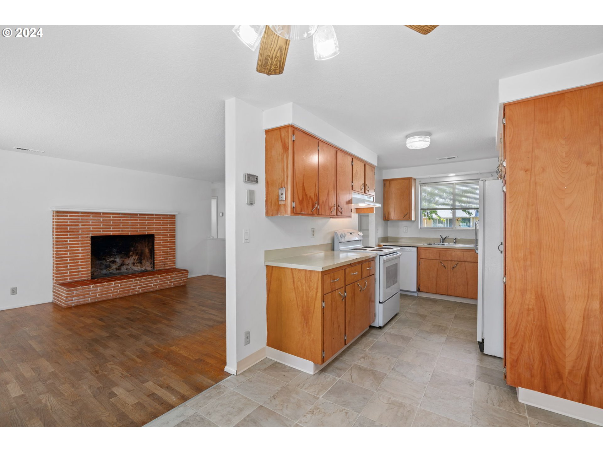 5246 E Street Springfield, OR 97478 - Photo 8 of 26 a large kitchen with cabinets and a fireplace