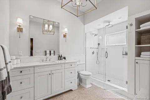 a spacious bathroom with a double vanity sink mirror and shower