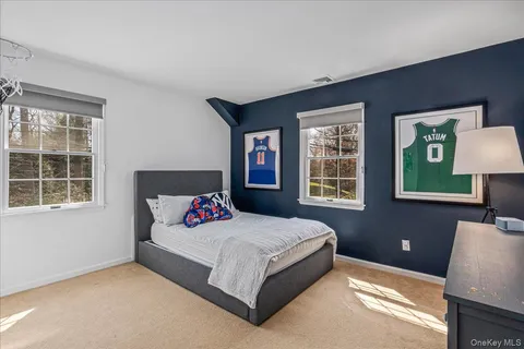 a bedroom with a bed lamp and a window