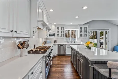 a kitchen with stainless steel appliances granite countertop a stove and a sink