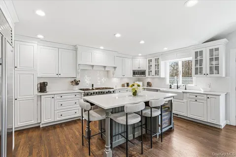 a kitchen with granite countertop white cabinets and white appliances