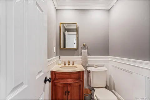 a bathroom with a toilet a sink and mirror