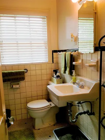 a bathroom with a sink a toilet and a mirror