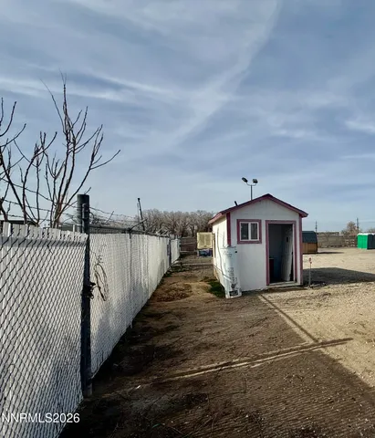 a view of a house with a wooden fence