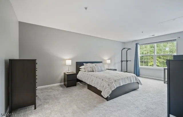 a bedroom with a large bed and a large window