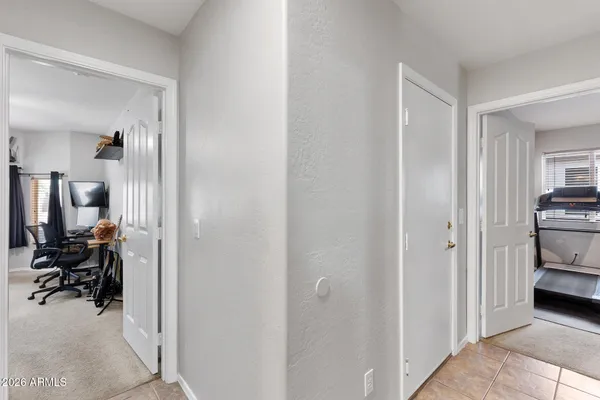 a view of a hallway with workspace and a livingroom with furniture