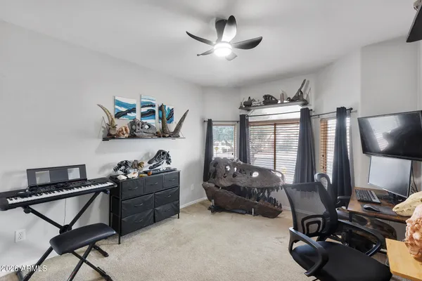 a workspace with furniture and ceiling fan