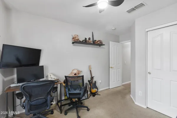 a view of a workspace with furniture and a window