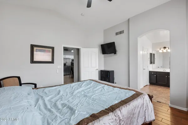 a bedroom with a bed and a flat screen tv