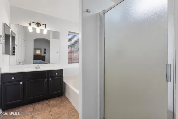 a spacious bathroom with a double vanity sink and a mirror