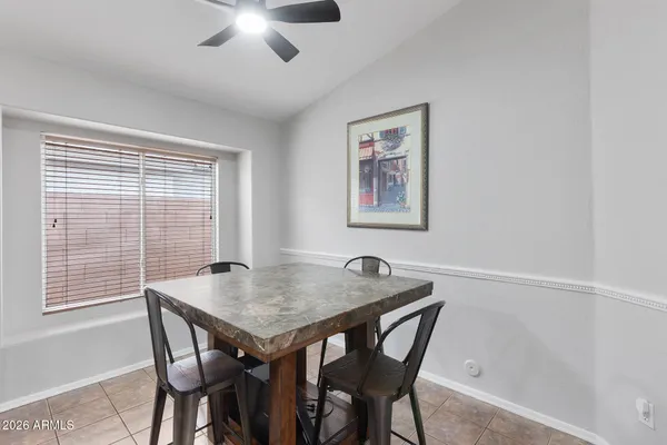 a view of a dining room with furniture and a window