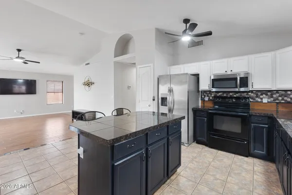 a kitchen with stainless steel appliances a stove sink and microwave