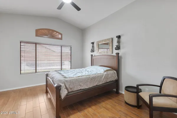 a bedroom with a bed and a chair