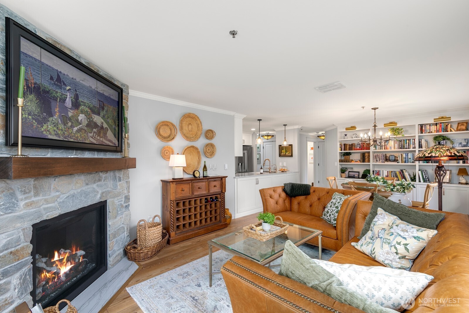 a living room with furniture a fireplace and a wall painting
