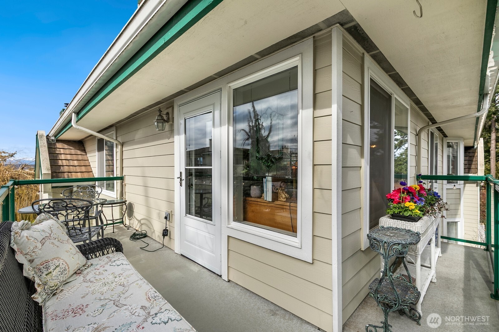 609 7th Avenue North, Unit B304 Edmonds, WA 98020 - Photo 19 of 26 a view of a porch with furniture and floor to ceiling window