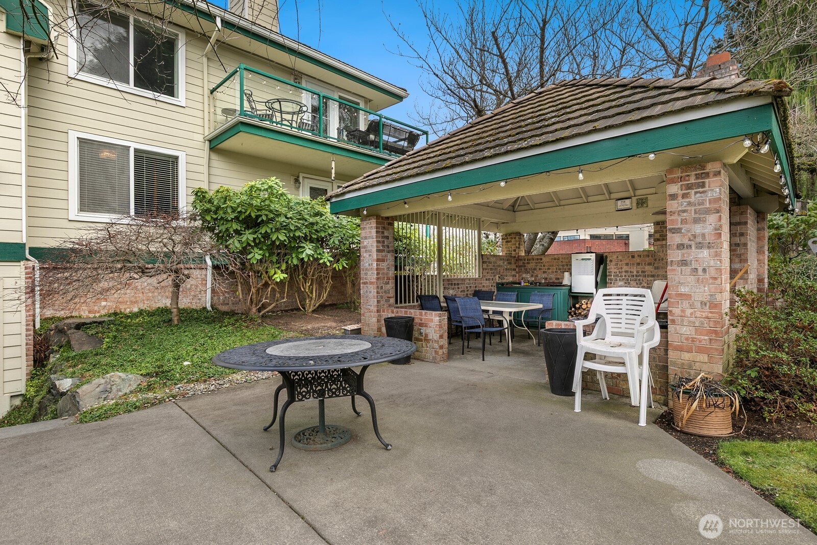 609 7th Avenue North, Unit B304 Edmonds, WA 98020 - Photo 25 of 26 a view of a chair and tables in the back yard of the house
