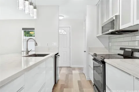 a kitchen with a sink stove and cabinets