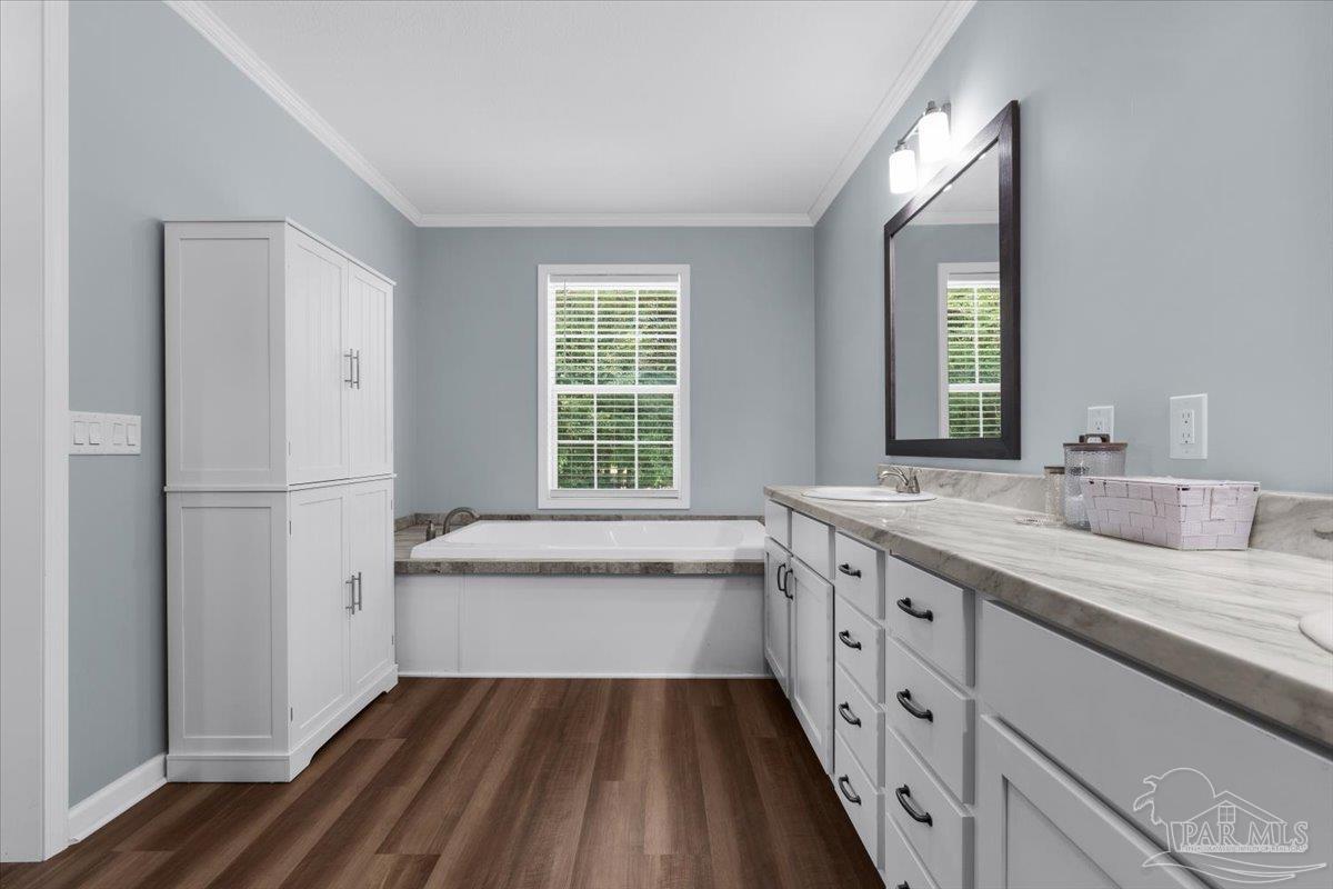 4955 Blue Ribbon Drive Milton, FL 32583 - Photo 11 of 32 a spacious bathroom with a granite countertop sink mirror and bathtub