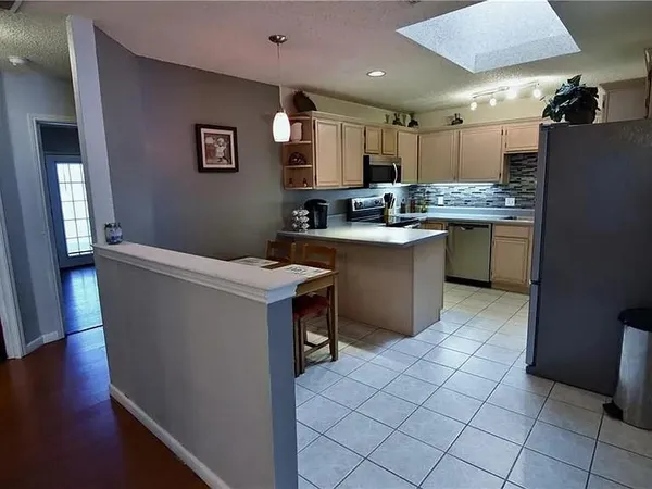 a kitchen with refrigerator and cabinets