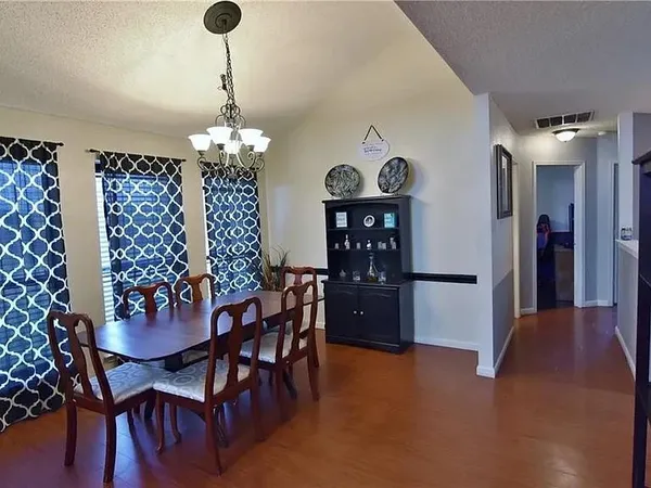 a view of a dining room with furniture and chandelier