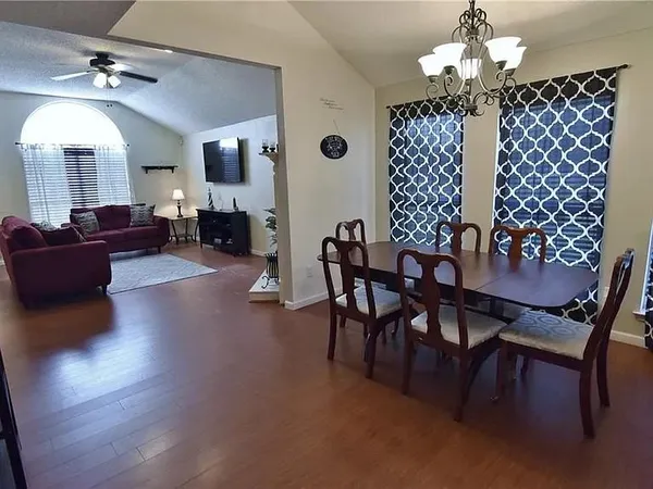 a view of a livingroom with furniture window and wooden floor