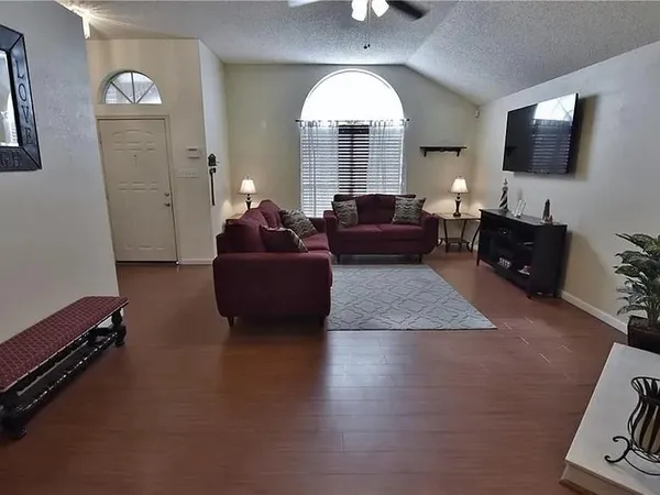 a living room with furniture and a flat screen tv