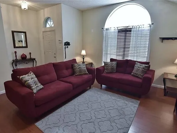 a living room with furniture and a large window