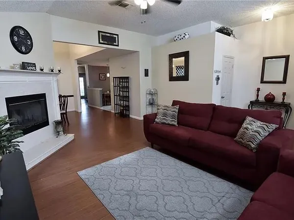 a living room with furniture a fireplace and a flat screen tv